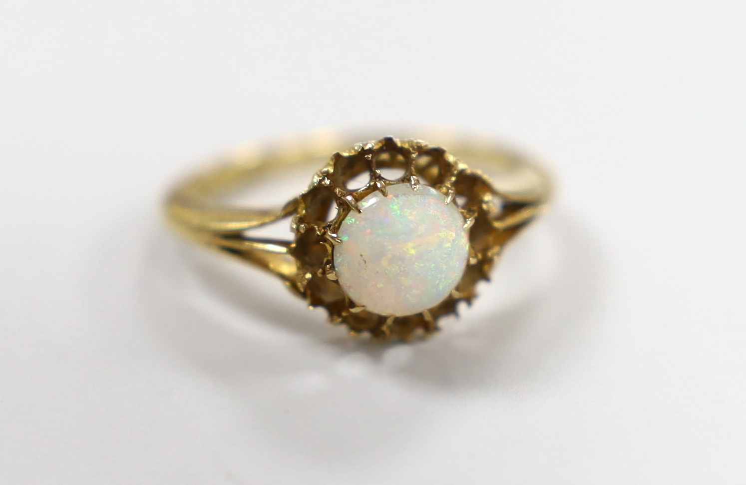 A late Victorian and single stone white opal set ring, size O/P, gross weight 3.9 grams (border stones missing).